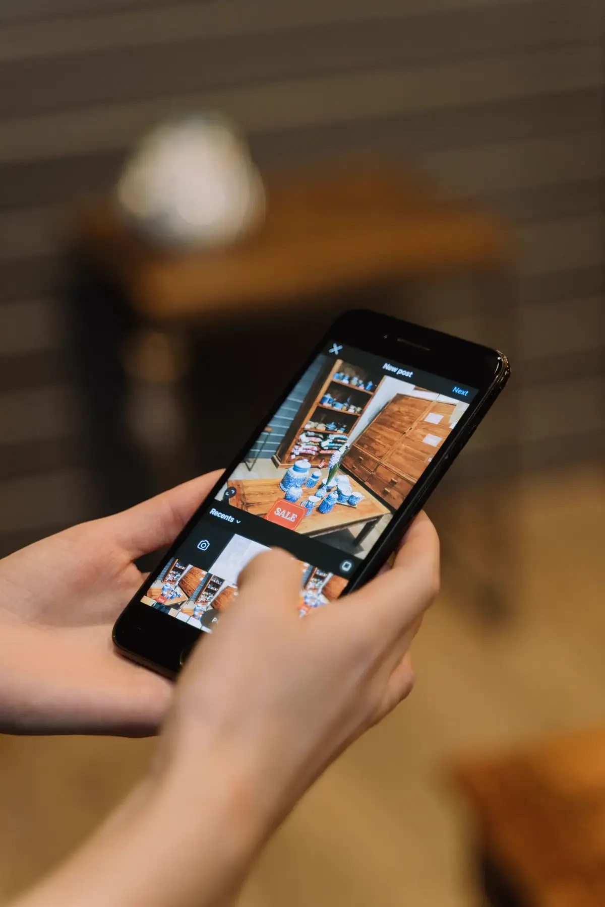 Hände fotografieren mit dem Smartphone ein Angebot im Ladenlokal